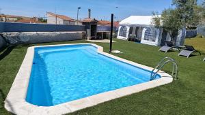 a swimming pool in a yard with a tent at Casa el moral 2 in Castillejo de Martín Viejo