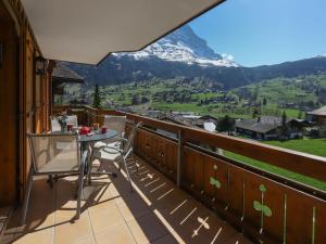 a balcony with a table and a view of a mountain at Apartment Chalet Nagano by Interhome in Grindelwald