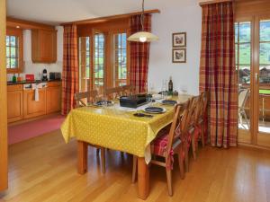 a kitchen with a table with a yellow table cloth at Apartment Chalet Nagano by Interhome in Grindelwald