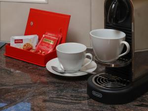 two coffee cups on a counter next to a toaster at Apartment Chalet Nagano by Interhome in Grindelwald +28 photos