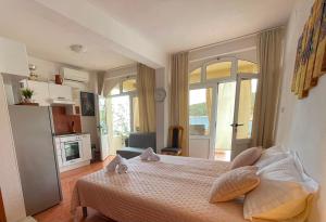a bedroom with a bed and a room with a fireplace at Studio apartment Milna, Hvar Buratovic in Hvar