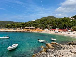 three boats in the water near a beach at Studio apartment Milna, Hvar Buratovic in Hvar