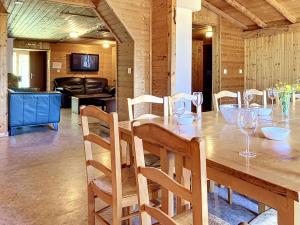 a dining room with a wooden table and chairs at Chalet Chalet Anthamatten-3 by Interhome in Champéry