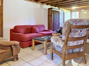 a living room with a couch and a table and chairs at Chalet Chalet Anthamatten-3 by Interhome in Champéry