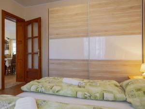 a large bed in a room with a large window at Holiday Home Tamas by Interhome in Balatonőszöd