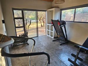 a room with a gym with two chairs and a window at Nkinga River Lodge in Balule Game Reserve