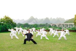 a group of people in white practicing karate at Yulonghe Yushan Country Hotel in Yangshuo