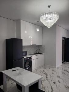 a kitchen with a table and a chandelier at MM House in Yerevan