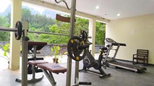 a gym with two tread machines in a room with a window at Sài Gòn - Bản Giốc Resort in Lũng Niêo