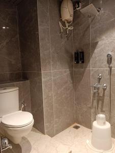 a bathroom with a toilet and a shower stall at VMR Hotel Port Blair in Jangli Ghāt +19 photos