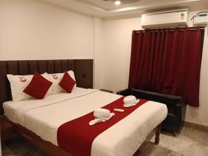 a bedroom with a bed with two towels on it at VMR Hotel Port Blair in Jangli Ghāt