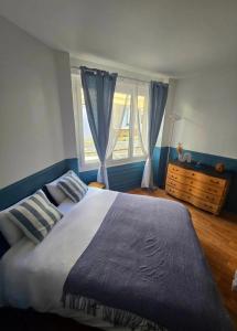 a bedroom with a large bed and a window at Au Petit Crecy in Crécy-la-Chapelle