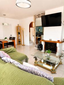 a living room with a couch and a tv at Blue House Calafell in Calafell