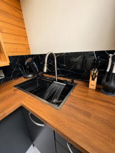 a kitchen sink with a faucet on a counter at Love room Coconut Secret in Le Gosier +15 photos