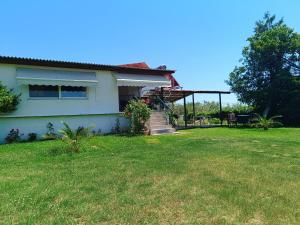 a house with a grassy yard next to a house at Maestro παραλία Καριανής in Karianí