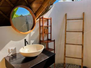 a bathroom with a bowl sink and a mirror at Circle House Bamboo Sidemen in Silebeng