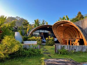 a garden with a wooden house and a shed at Circle House Bamboo Sidemen in Silebeng +10 photos