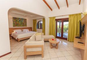 a bedroom with a bed and a living room at Valmer Resort and Spa in Baie Lazare Mahé +144 photos