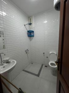 a white bathroom with a toilet and a sink at Voya Residence Dahab in Dahab