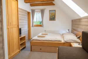 a bedroom with two beds and a window at Andrejkin dom in Blatnica