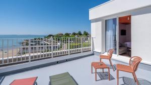 a balcony with chairs and a view of the ocean at Kyriad - Royan Plage in Royan +30 photos