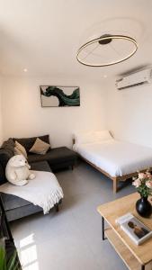 a living room with two beds and a couch at KL Studios in Al Khobar