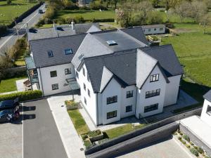 an aerial view of a large white house at Glynllifon 9 in Llanallgo