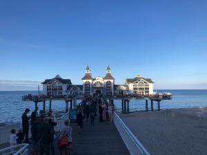 a group of people walking on a pier at Strandläufer in Breege