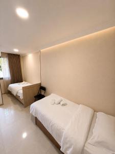 a hotel room with two beds with white sheets at Old Tbilisi in Itʼkhvisi