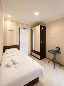 a bedroom with a large bed and a table at Old Tbilisi in Itʼkhvisi