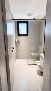 a bathroom with a toilet and a glass shower door at KL Studios in Al Khobar +11 photos