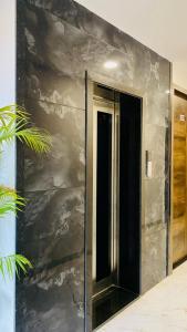 a building with a black and silver wall at Hotel Rove Inn in Indore