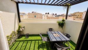 a patio with a table and chairs on a balcony at KL Studios in Al Khobar