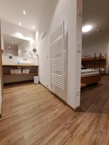 a large room with a bed and a wooden floor at Pension Yvonne - SUPERIOR - am Europa-Park in Rust +51 photos