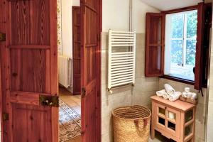 a room with an open door with a table and a window at Hotel Can Abril in Sóller +54 photos