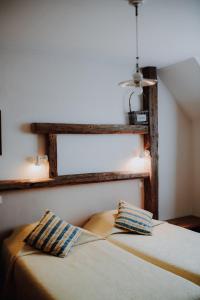 a bedroom with a bed with two pillows on it at Auberge d'Anthy in Anthy