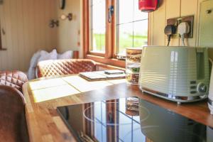 a microwave sitting on top of a wooden table at Rose in Rhayader