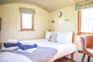 a bed in a room with two towels on it at Rose in Rhayader