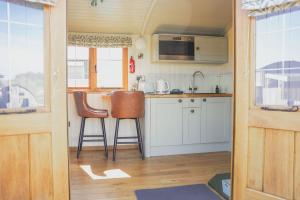 a kitchen with a table and chairs in a tiny house at Rose in Rhayader +19 photos