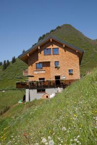 a large building on top of a hill at Jägerstüble in Damuls