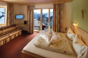 a hotel room with a bed with pillows on it at Jägerstüble in Damuls