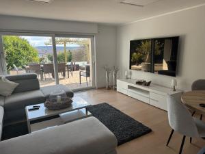 a living room with a couch and a table at Ferienoase am See in Möhnesee