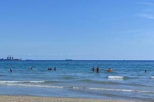 a group of people in the water at the beach at Promar La Pineda Port Aventura in La Pineda