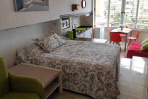 a bedroom with a bed and a table and chairs at Promar La Pineda Port Aventura in La Pineda