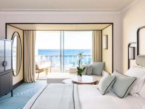 a hotel room with a bed and a large window at Mondrian Cannes in Cannes +169 photos