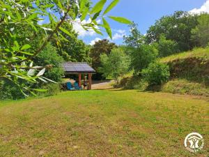 a gazebo in the middle of a grass field at Grésigne in Larroque