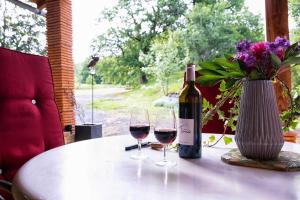 a bottle of wine and two glasses on a table at Grésigne in Larroque