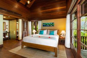 a bedroom with a bed in a room at Enchanted Island Resort in Mahe