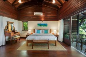 a bedroom with a bed and a wooden ceiling at Enchanted Island Resort in Mahe +51 photos