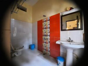 a bathroom with a sink and a mirror and a toilet at Rumis Jaisalmer in Jaisalmer +29 photos